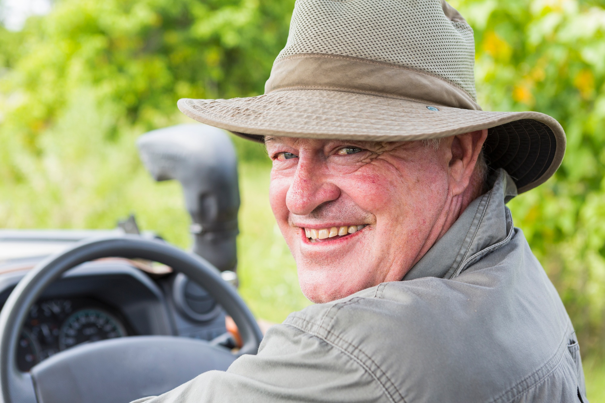 Benson Safaris | Portrait of smiling safari guide in a bush hat