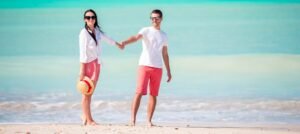 Benson Safaris | Young couple on white beach. Happy family on honeymoon vacation