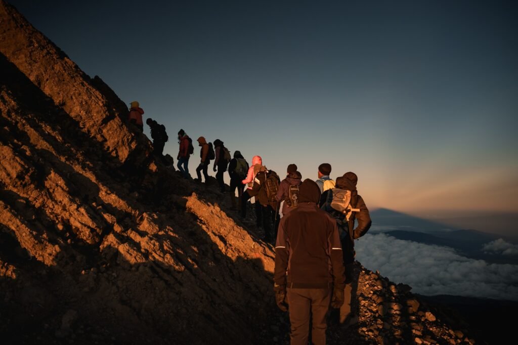 Benson Safaris | Mount Meru | Mountaineers reaching mount meru summit at sunrise, tanzania, africa