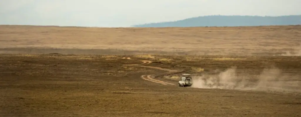 Safari jeeps crossing Serengeti, Tanzania, Africa