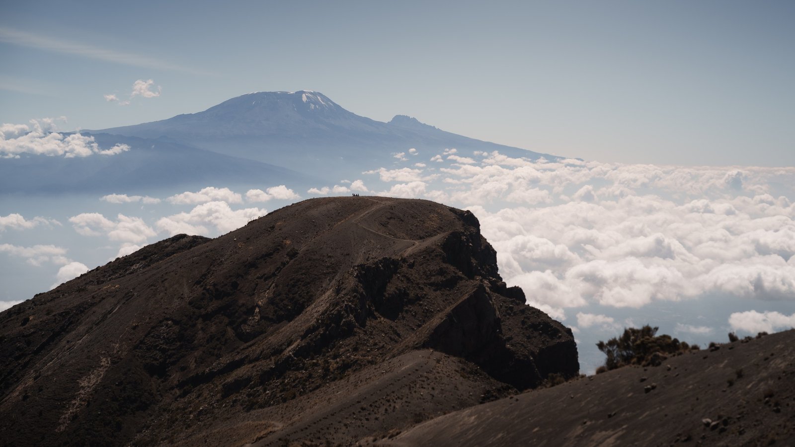 Reaching mount meru summit with kilimanjaro in the background